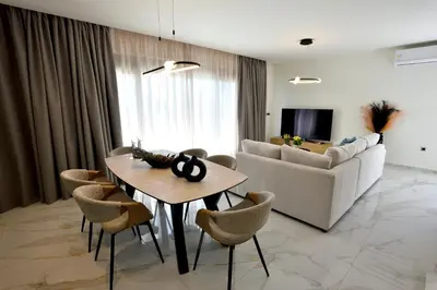 a living room with a table and a couch at Villa 101 Rhodes in Ixia