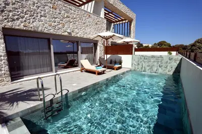a swimming pool in front of a house at Villa 101 Rhodes in Ixia