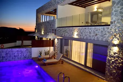 a villa with a swimming pool at night at Villa 101 Rhodes in Ixia