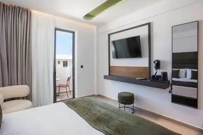 a hotel room with a bed and a mirror at Ermou 44 City Hotel in Faliraki