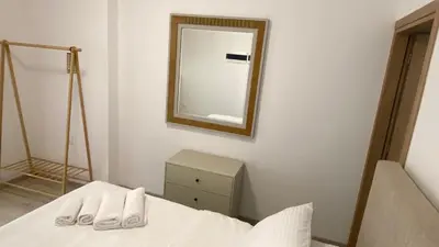 a bedroom with a bed and a mirror on the wall at Rhodes Beach Side Houses in Ixia