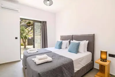 a bedroom with a large bed with towels on it at Villa Zen Zazan by Villa Plus in Kolimbia