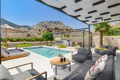 a villa with a swimming pool and a patio at Villa Zen Zazan by Villa Plus in Kolimbia