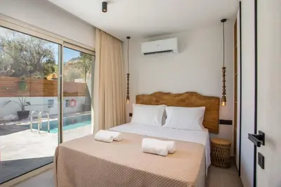 a bedroom with a bed with two towels on it at Aura Luxury Villas in Kolimbia