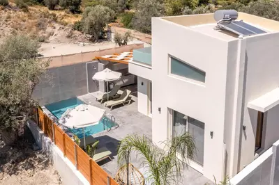 an aerial view of a house with a swimming pool at Aura Luxury Villas in Kolimbia