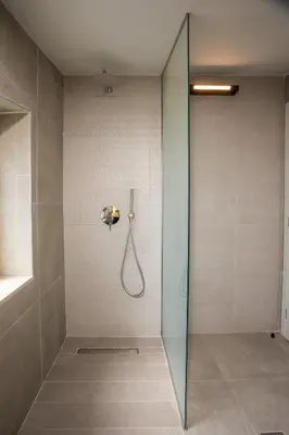 a shower with a glass door in a bathroom at Aura Luxury Villas in Kolimbia