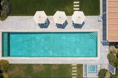 an overhead view of a swimming pool with umbrellas at Villa Ramann, Rhodes in Rhodes Town