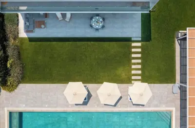 an overhead view of a swimming pool with umbrellas and a pool at Villa Ramann, Rhodes in Rhodes Town