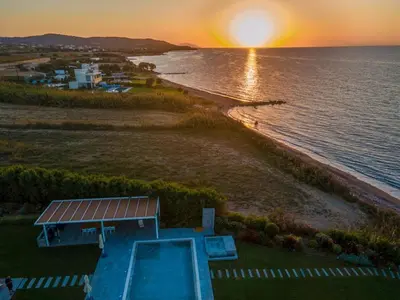 an aerial view of a beach and the ocean at sunset at Villa Ramann, Rhodes in Rhodes Town