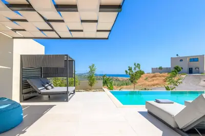 a villa with a swimming pool and a patio at Villa Trapezia Diamond in Kolimbia