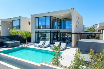a house with a swimming pool in front of it at Villa Trapezia Diamond in Kolimbia