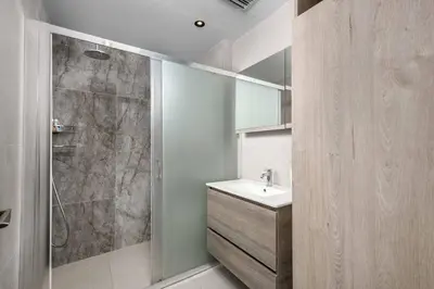 a bathroom with a sink and a shower at Villa Trapezia Diamond in Kolimbia