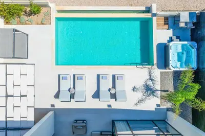 a swimming pool on the side of a building at Villa Trapezia Diamond in Kolimbia