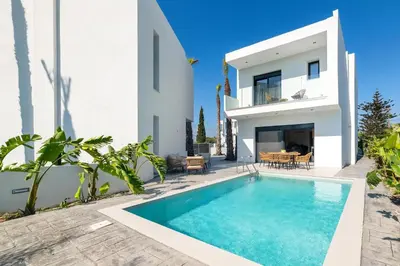 a villa with a swimming pool and a house at Davlakos Apartments Rea in Kremasti