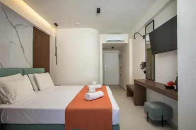 a bedroom with a bed with a teddy bear on it at Aurora Living - Adults Only in Faliraki