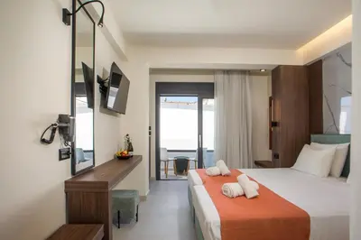 a hotel room with a bed with two pillows on it at Aurora Living - Adults Only in Faliraki