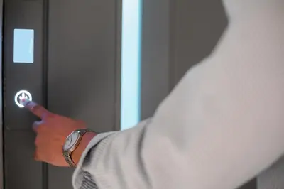 a man is opening a door with a button at Aurora Living - Adults Only in Faliraki