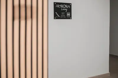 a white wall with a sign on it at Aurora Living - Adults Only in Faliraki