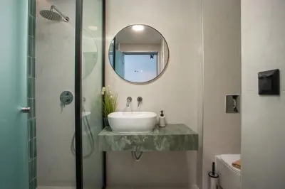 a bathroom with a sink and a mirror at Aurora Living - Adults Only in Faliraki