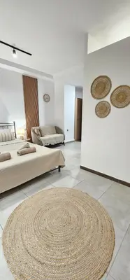 a large room with two beds and a large rug at Spiti Studio City Center in Rhodes Town