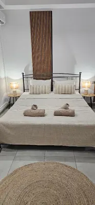 a bedroom with a large bed with two pillows on it at Spiti Studio City Center in Rhodes Town