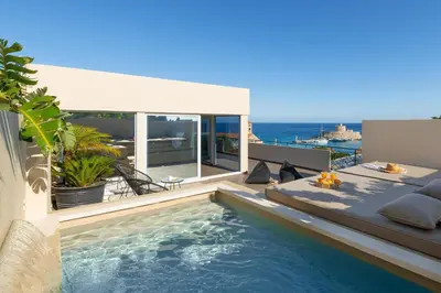 a swimming pool with a view of the ocean at Hamilton Elite Penthouse in Rhodes Town