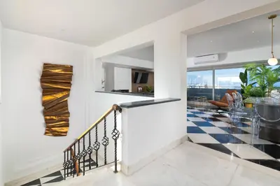 a staircase in a house with a checkered floor at Hamilton Elite Penthouse in Rhodes Town
