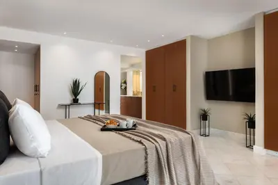 a bedroom with a bed with a tray of food on it at Hamilton Elite Penthouse in Rhodes Town