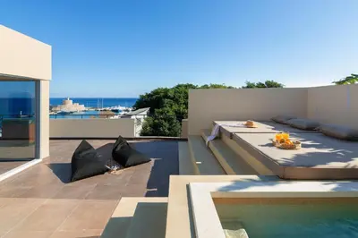 a bedroom with a bed and a swimming pool at Hamilton Elite Penthouse in Rhodes Town