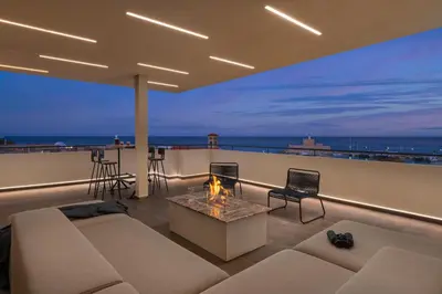a living room with a couch and a fireplace on a roof at Hamilton Elite Penthouse in Rhodes Town