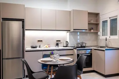 a small kitchen with a table and chairs in it at Corner Apartment in Ialyssos