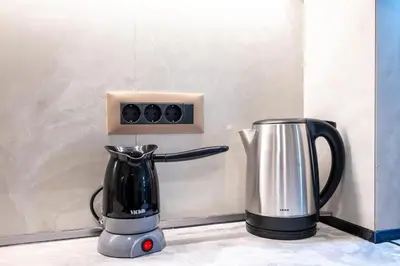 a blender and a coffee pot on a counter at Corner Apartment in Ialyssos