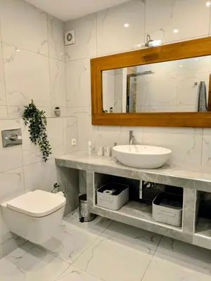 a bathroom with a sink and a toilet and a mirror at Costelia Studio in Ialyssos