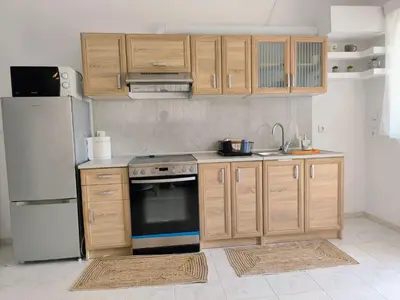 a kitchen with a stove and a refrigerator at Costelia Studio in Ialyssos