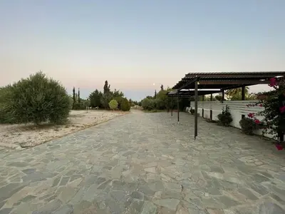 a stone walkway with a pavilion in a park at Xenia Terra in Kiotari