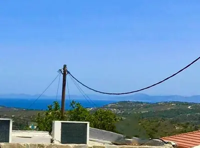 a telephone pole with a view of the ocean at Maison de Léa in Sálakos
