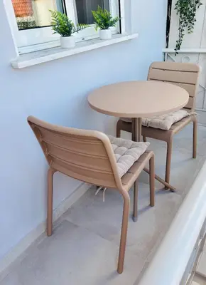 a table and a chair and a table and a table at Maison de Léa in Sálakos