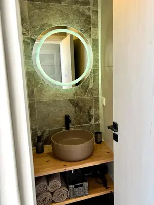 a bathroom with a sink and a mirror on the wall at Maison de Léa in Sálakos