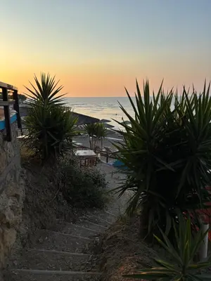 a pathway leading to the beach at sunset at Maison de Léa in Sálakos