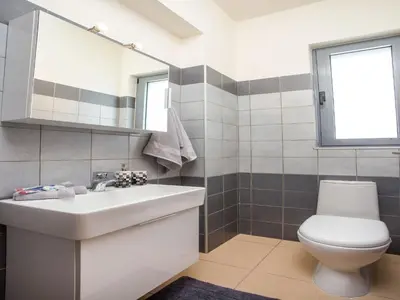 a bathroom with a white sink and a toilet at 2-Bedroom Villa with Private Pool in Kalithies in Faliraki