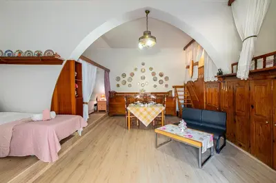 a bedroom with two beds and a table in it at La Casa Lemonià in Soroni