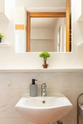 a bathroom with a sink and a mirror at La Casa Lemonià in Soroni