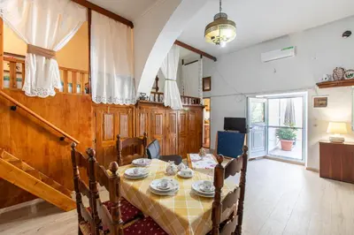 a dining room with a table with dishes on it at La Casa Lemonià in Soroni
