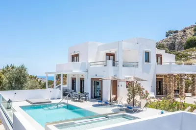 a villa with a swimming pool and a house at Aggelina Pefkos in Pefki Rhodes