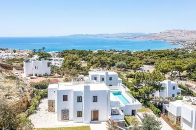 a white house with a view of the ocean at Aggelina Pefkos in Pefki Rhodes