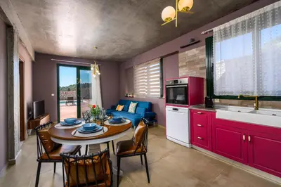 a kitchen and dining room with a table and chairs at Alki Slow Living Apartments in Rhodes Town