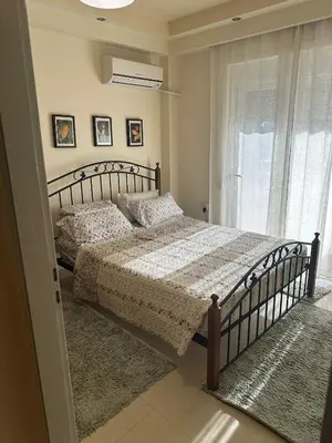 a bedroom with a bed and a window at Sunny Garden in Koskinou