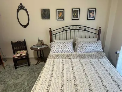 a bedroom with a large bed and a mirror at Sunny Garden in Koskinou