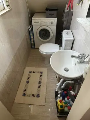 a small bathroom with a sink and a toilet at Sunny Garden in Koskinou
