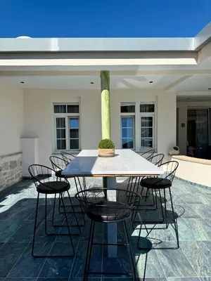 a table with chairs and a vase on a patio at Casa Loma 2 in Rhodes Town